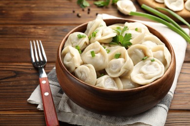 Photo of Delicious dumplings served on wooden table, closeup