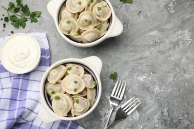 Photo of Delicious dumplings served on grey table, flat lay. Space for text