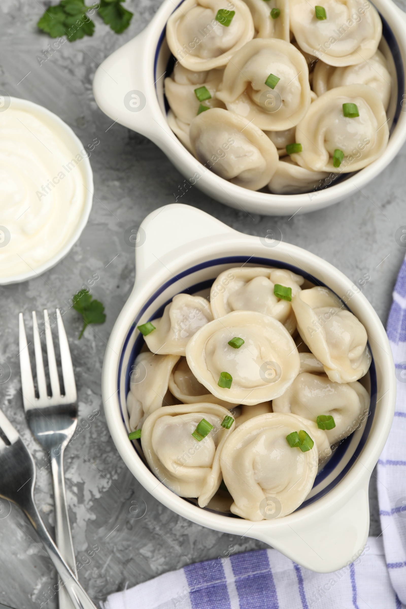 Photo of Delicious dumplings served on grey table, flat lay