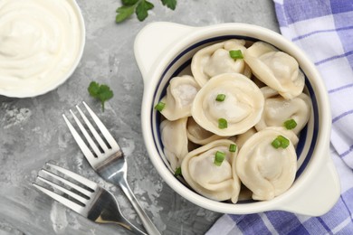 Photo of Delicious dumplings served on grey table, flat lay