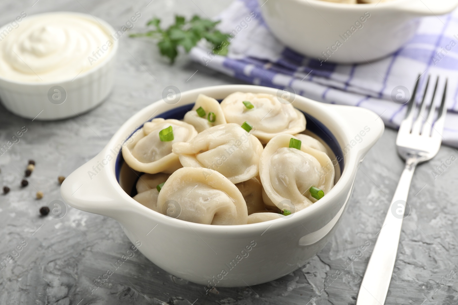 Photo of Delicious dumplings served on grey table, closeup