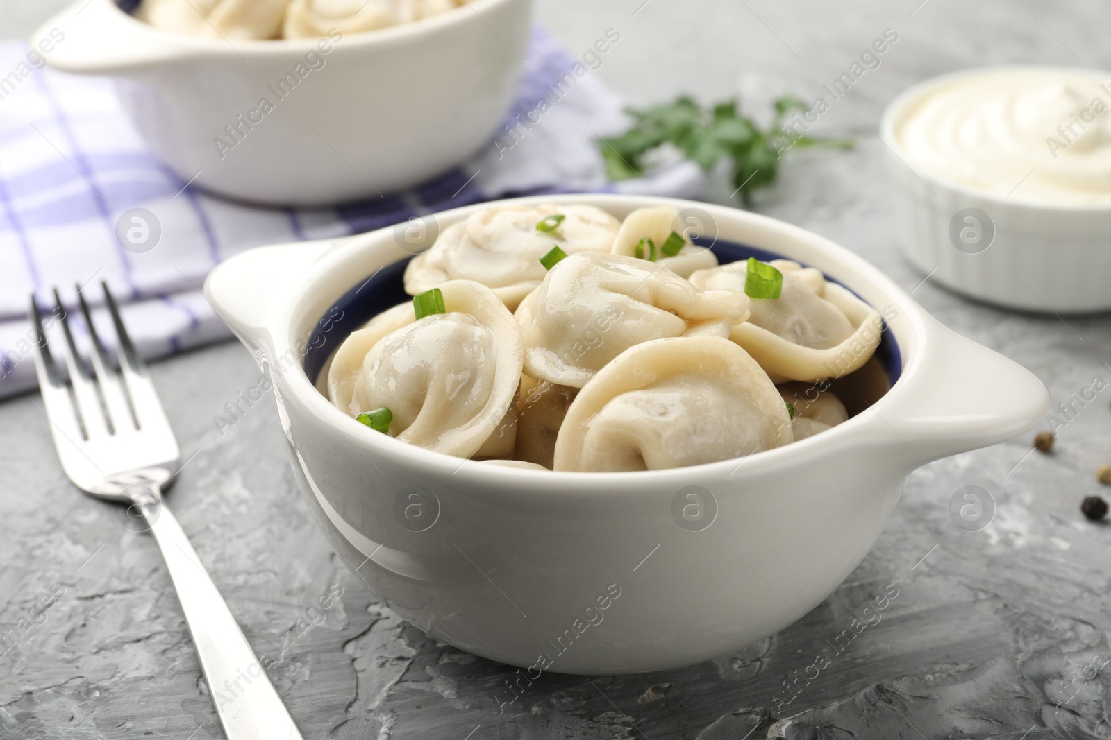 Photo of Delicious dumplings served on grey table, closeup