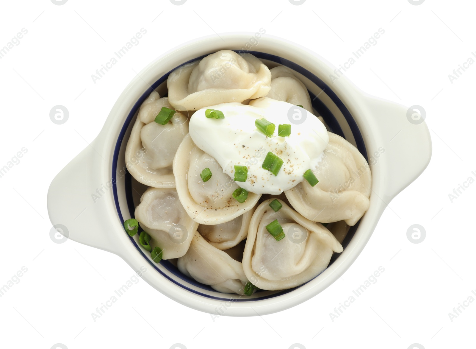 Photo of Delicious dumplings (pelmeni) with green onion and sour cream in bowl isolated on white, top view