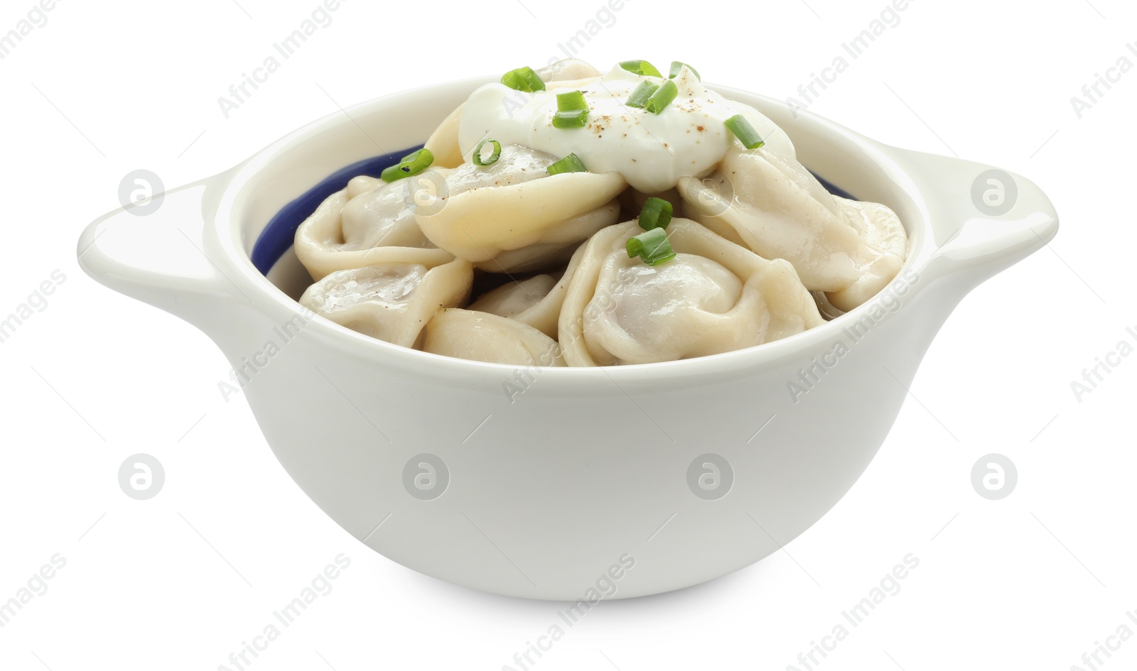 Photo of Delicious dumplings (pelmeni) with green onion and sour cream in bowl isolated on white