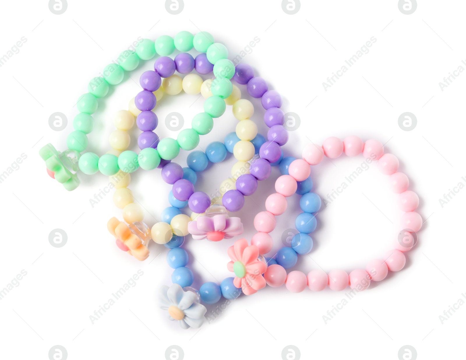 Photo of Colorful hair ties with flowers isolated on white, top view