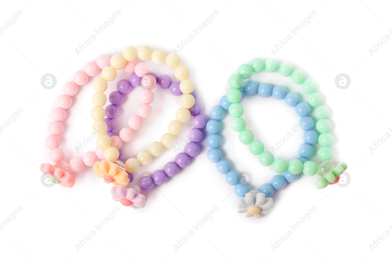 Photo of Colorful hair ties with flowers isolated on white, top view