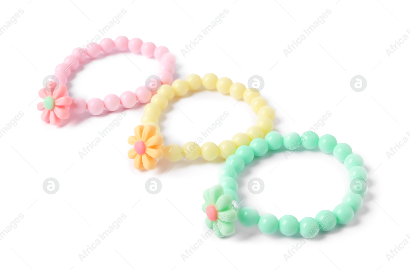 Photo of Colorful hair ties with flowers isolated on white