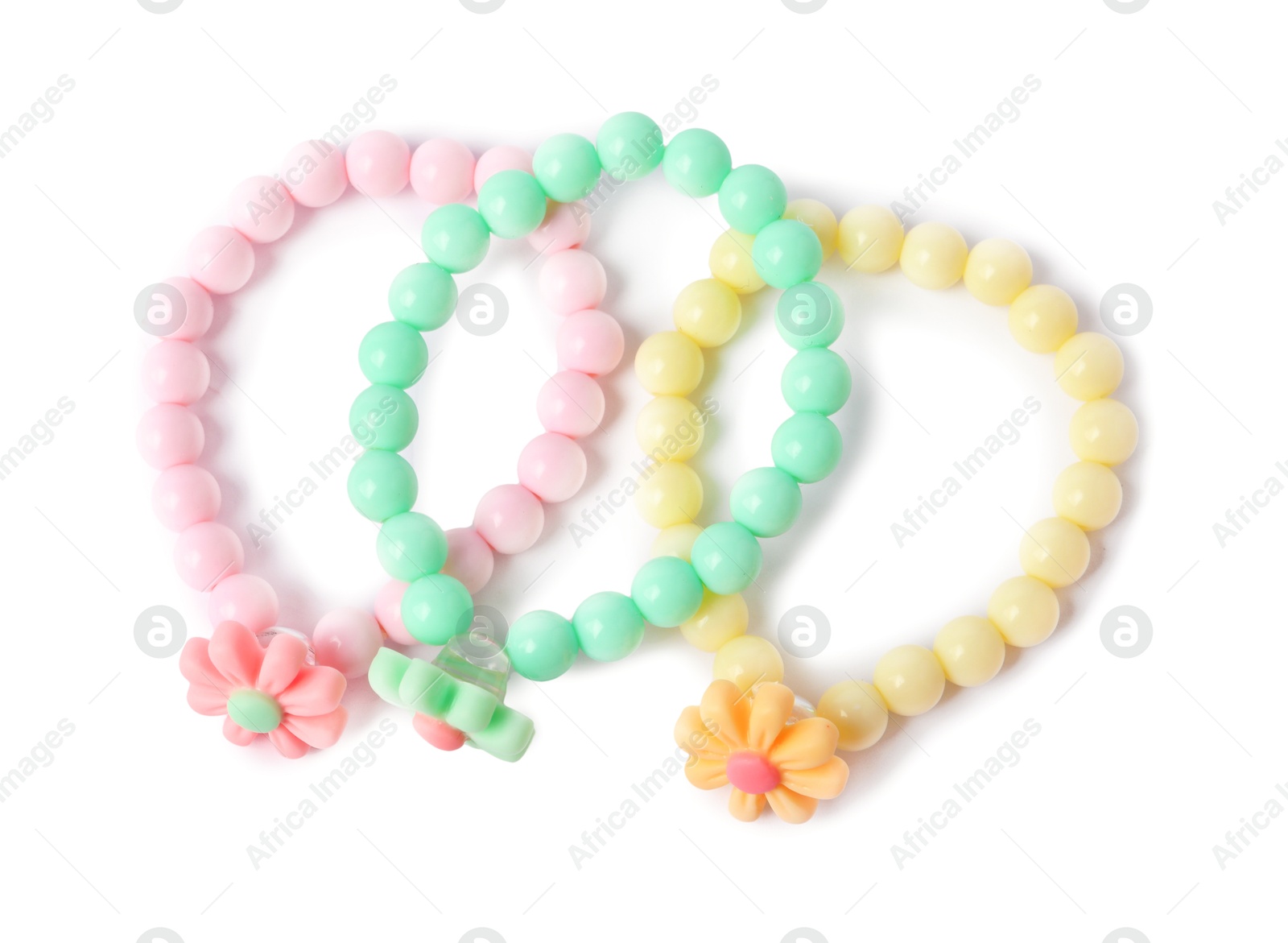 Photo of Colorful hair ties with flowers isolated on white, top view