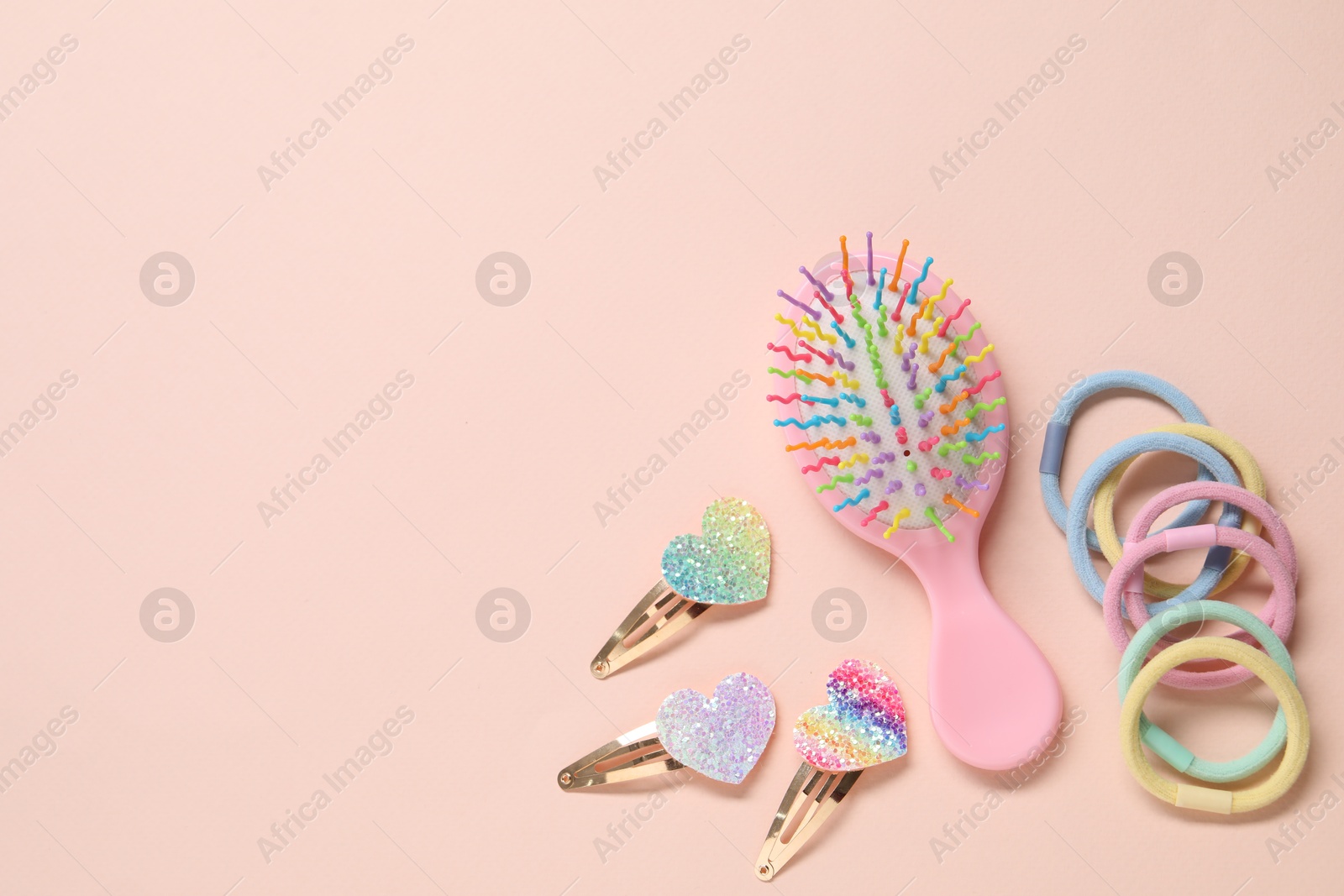 Photo of Colorful hair accessories on pink background, flat lay. Space for text