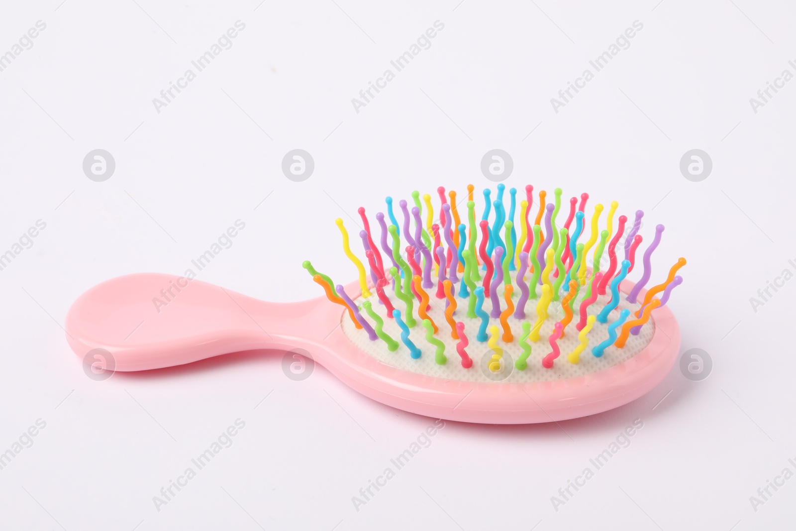 Photo of One colorful hair brush on white background