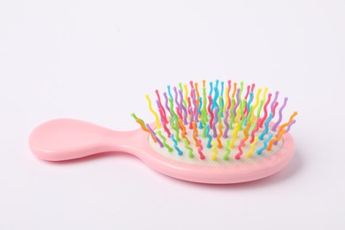 Photo of One colorful hair brush on white background