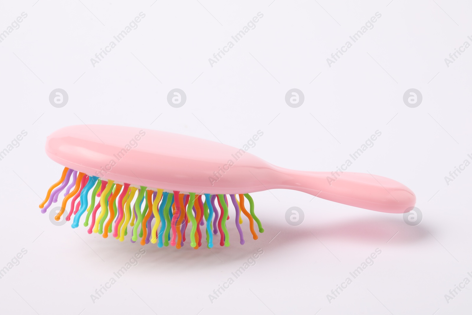 Photo of One colorful hair brush on white background