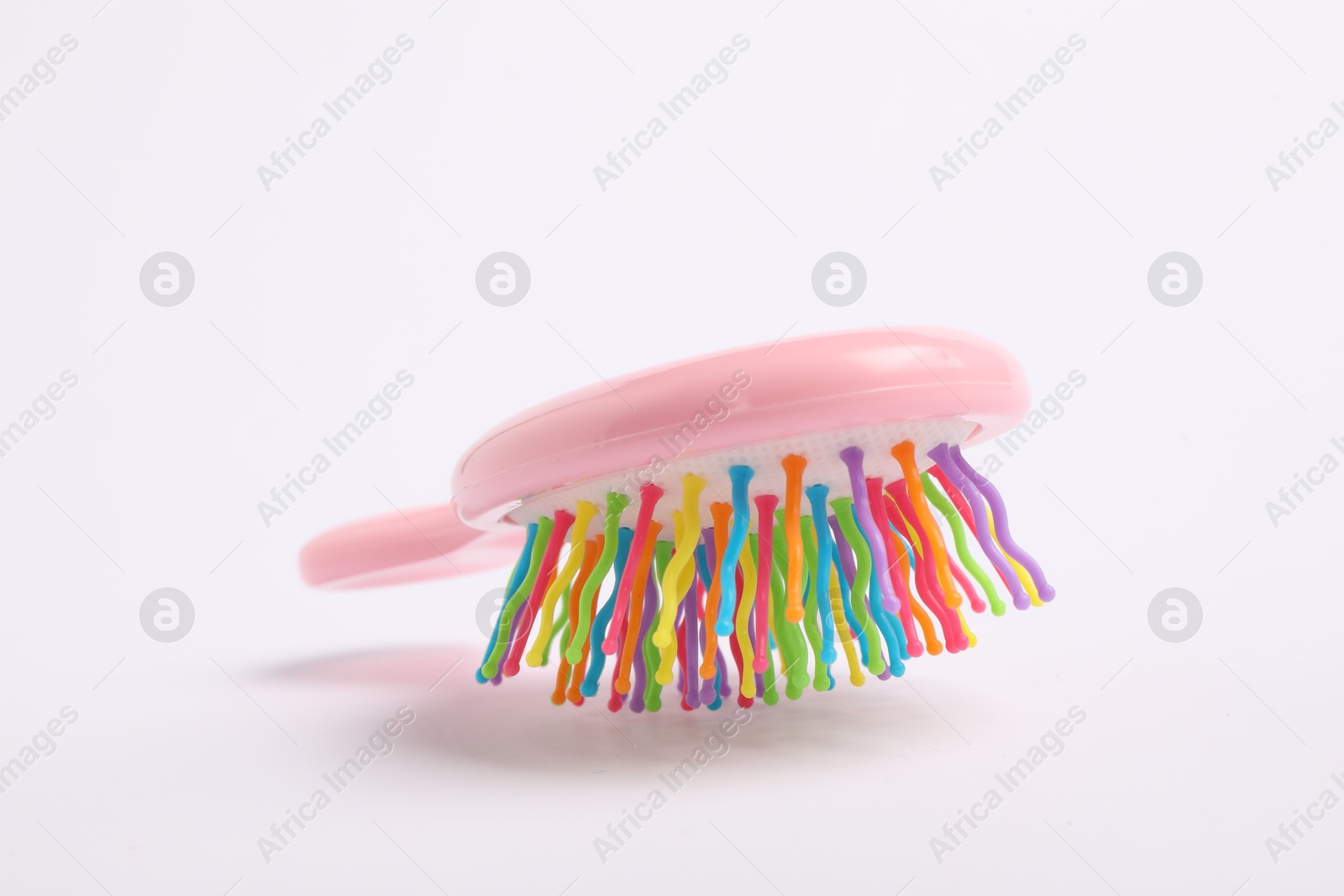 Photo of One colorful hair brush on white background