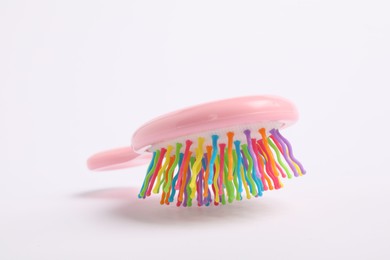 Photo of One colorful hair brush on white background