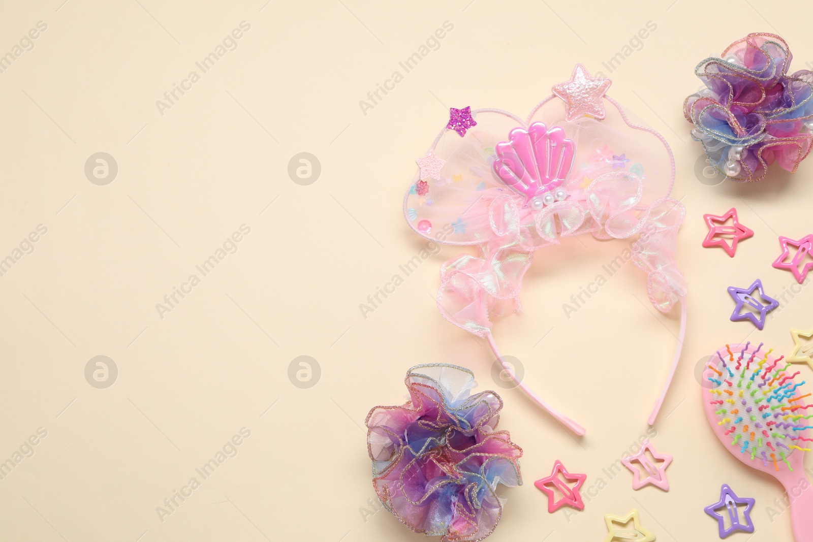 Photo of Cute hair accessories on beige background, flat lay. Space for text