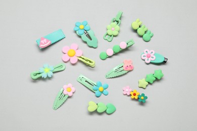 Photo of Cute hair clips on light background, flat lay