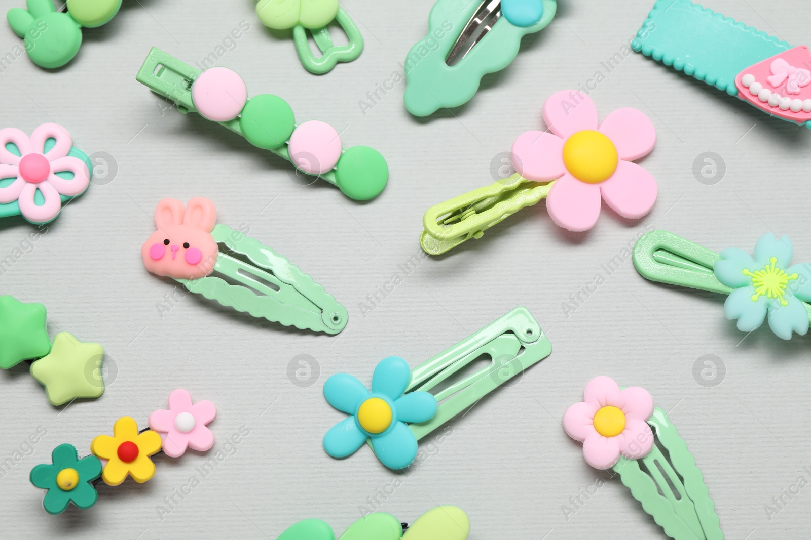 Photo of Cute hair clips on light background, flat lay