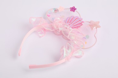 Photo of Cute pink headband on white background. Hair accessory