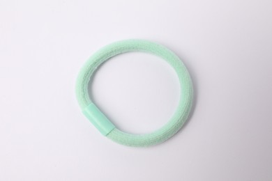 Photo of One green hair tie on white background, top view