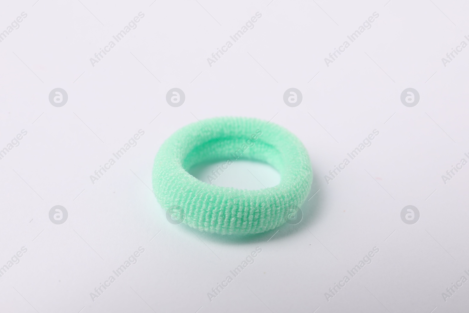 Photo of One green hair tie on white background