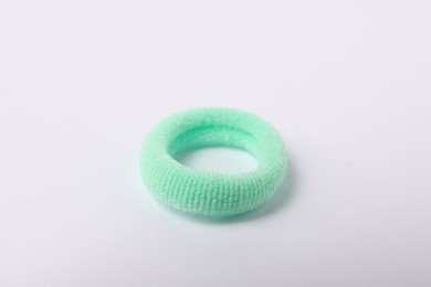 Photo of One green hair tie on white background