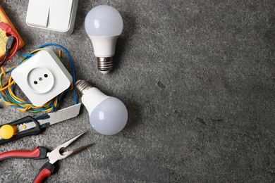 Photo of Different electrical tools on grey table, flat lay. Space for text