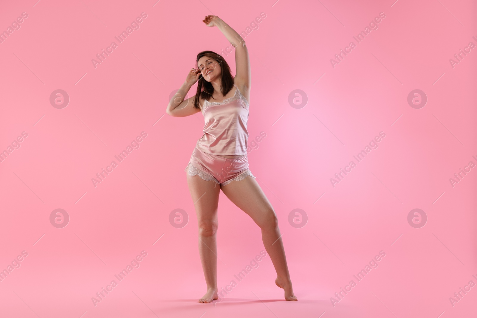 Photo of Woman in underwear on pink background. Cellulite problem