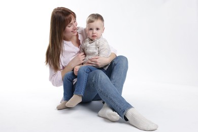 Photo of Mother and her cute son on white background