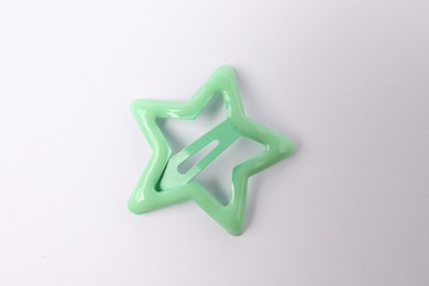 Photo of One green star shaped hair clip on white background, top view