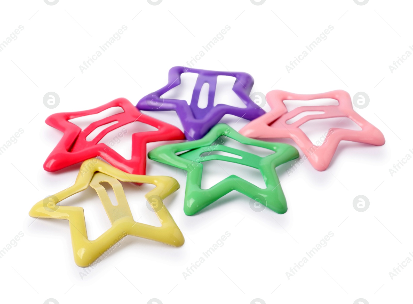 Photo of Many colorful star shaped hair clips isolated on white