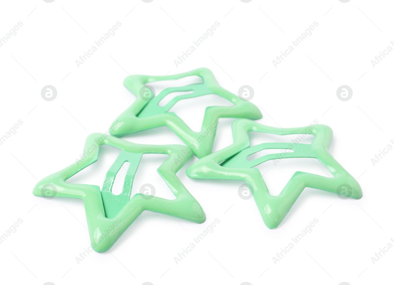 Photo of Many green star shaped hair clips isolated on white