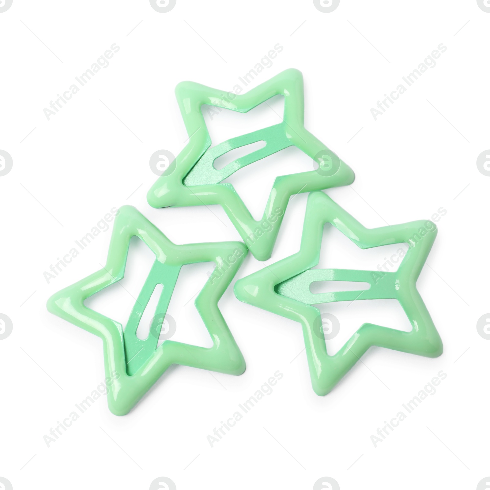 Photo of Many green star shaped hair clips isolated on white, top view