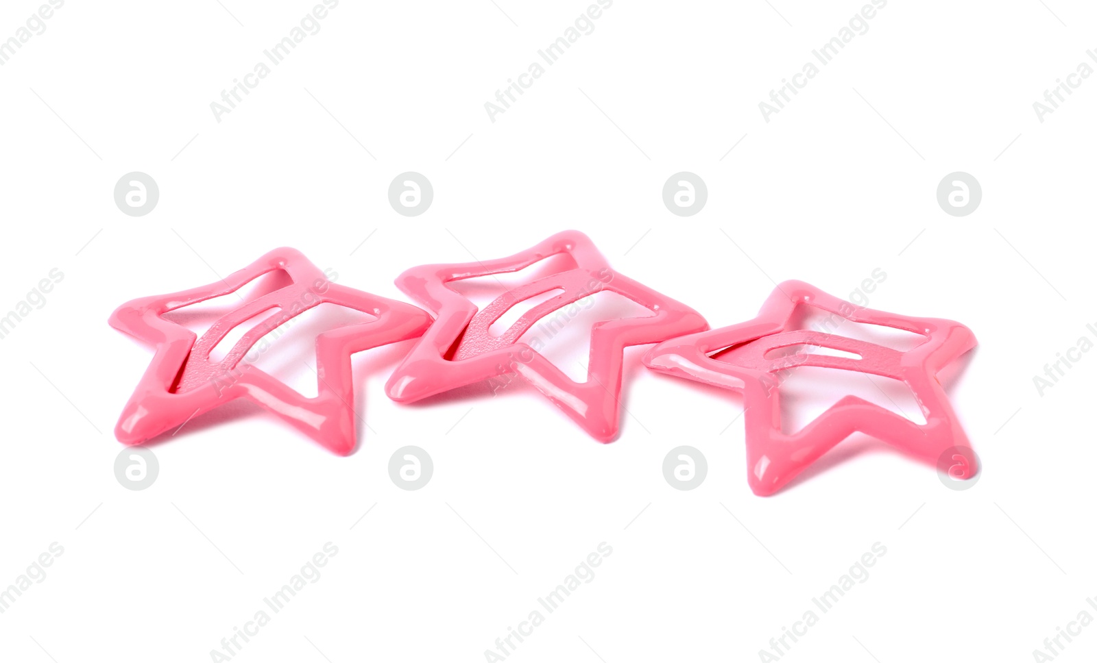 Photo of Many pink star shaped hair clips isolated on white