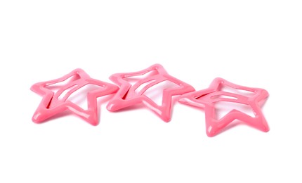 Photo of Many pink star shaped hair clips isolated on white