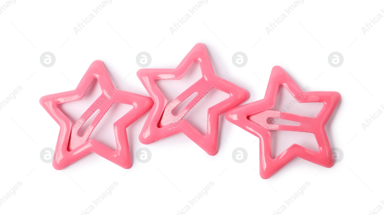 Photo of Many pink star shaped hair clips isolated on white, top view