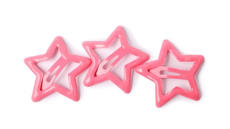 Photo of Many pink star shaped hair clips isolated on white, top view