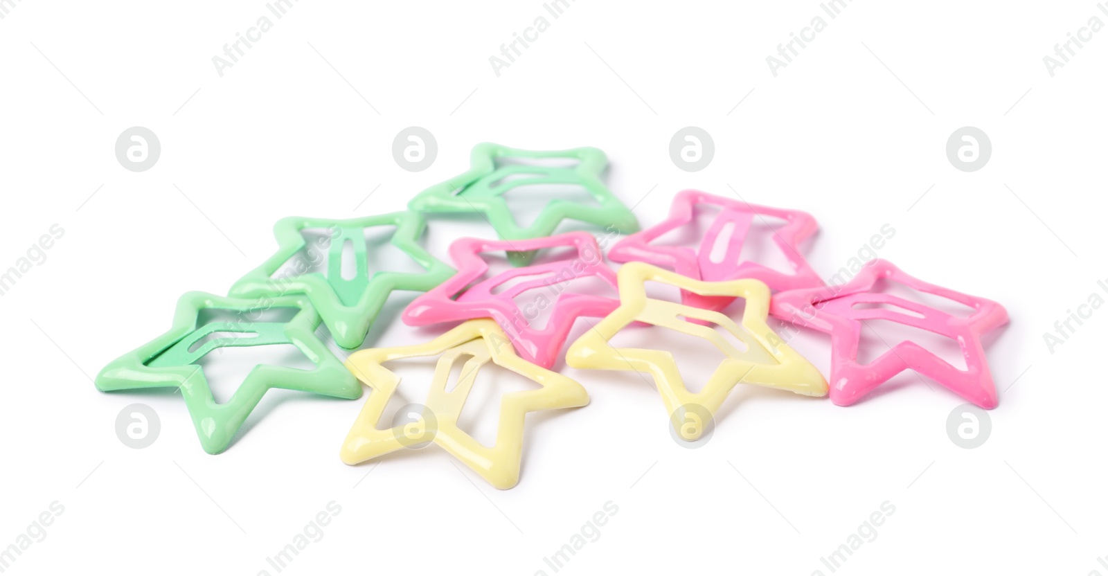 Photo of Many colorful star shaped hair clips isolated on white