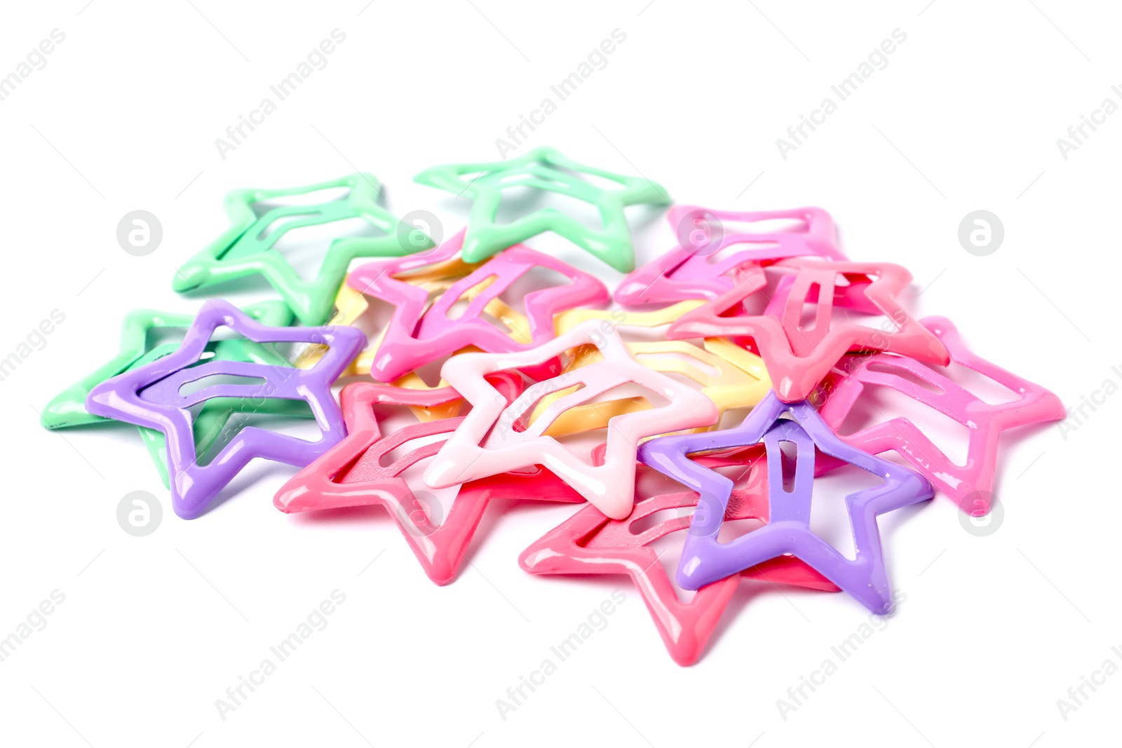 Photo of Many colorful star shaped hair clips isolated on white