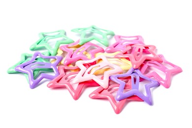 Photo of Many colorful star shaped hair clips isolated on white