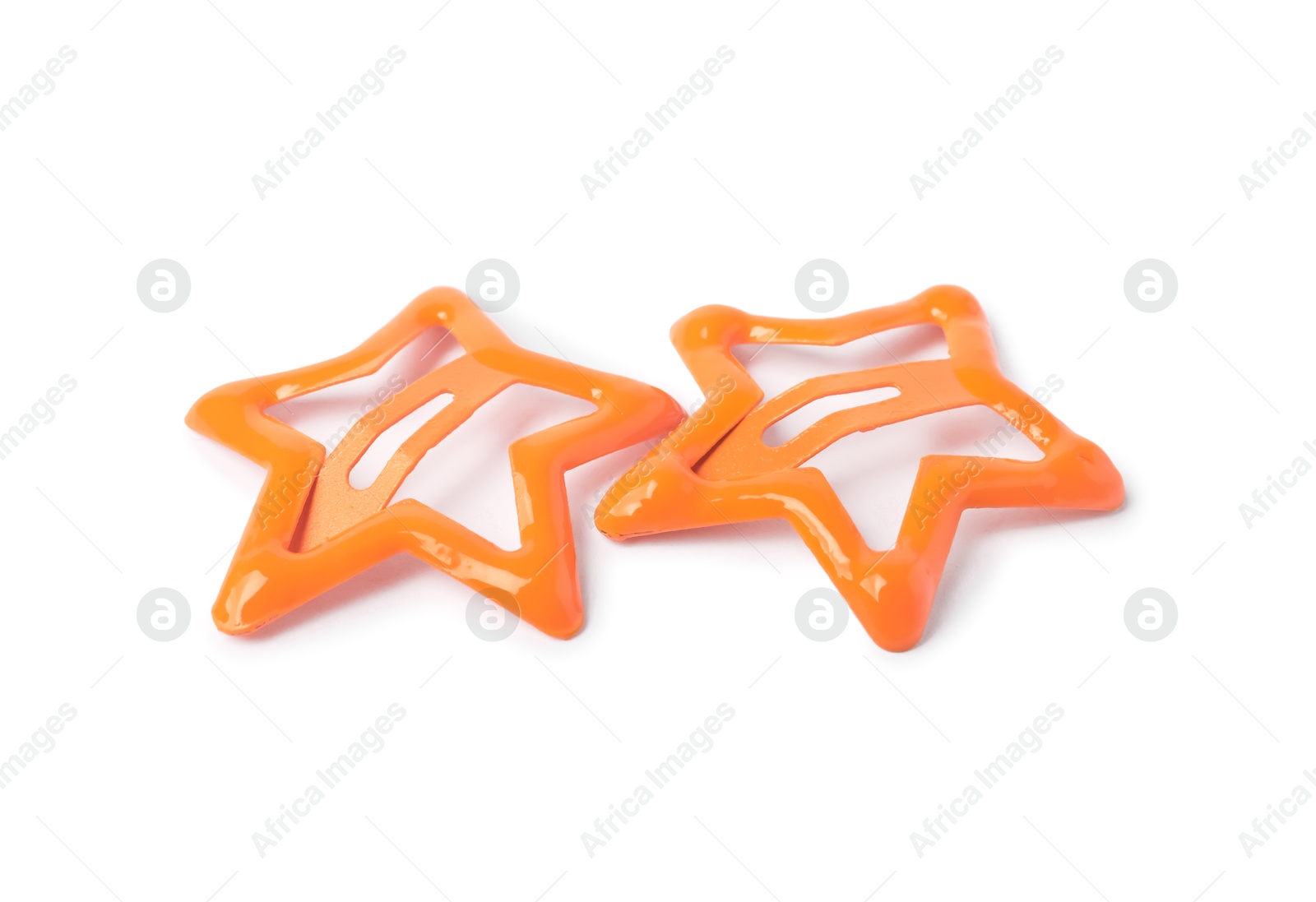 Photo of Two orange star shaped hair clips isolated on white