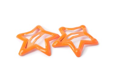 Photo of Two orange star shaped hair clips isolated on white