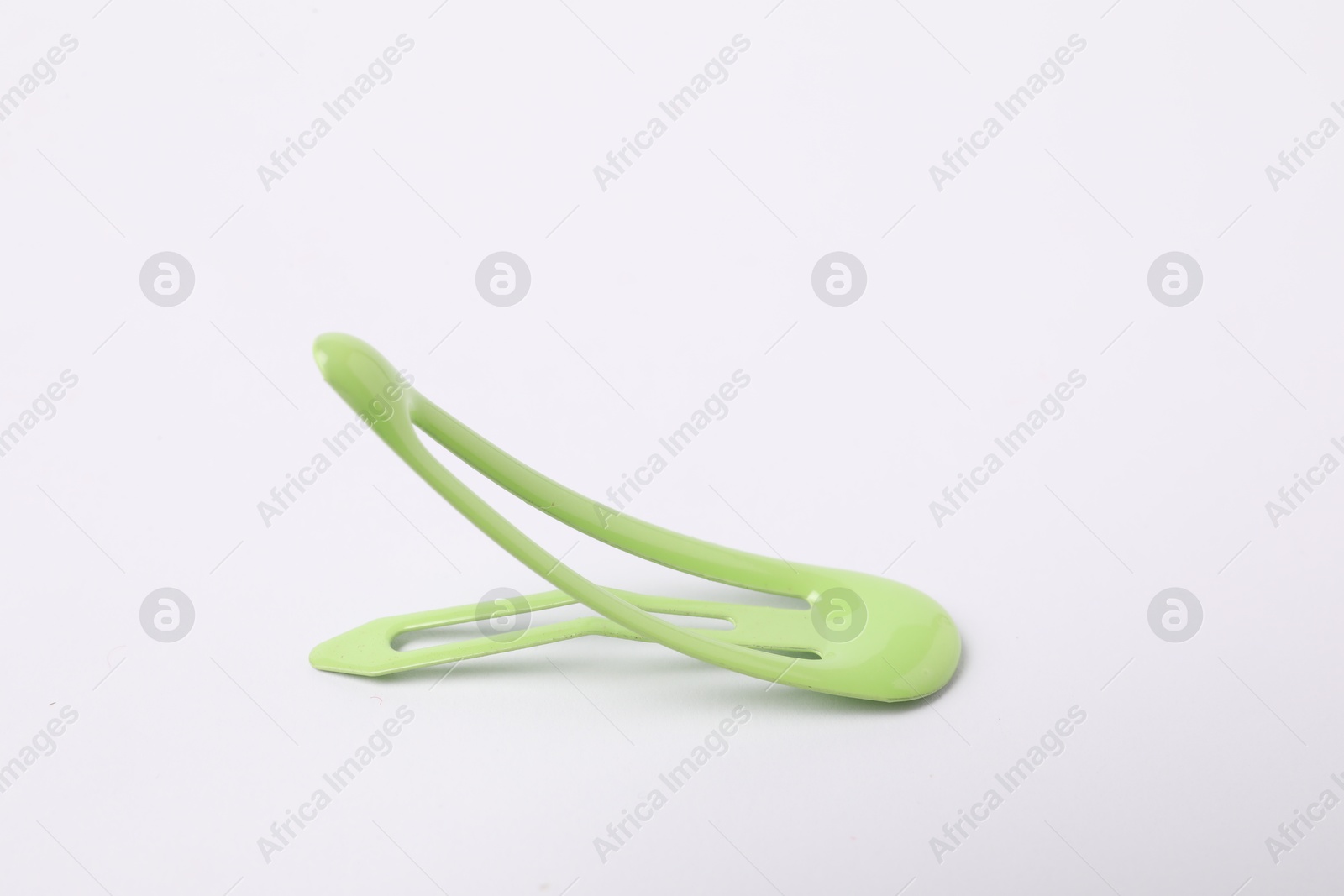 Photo of One green hair clip on white background