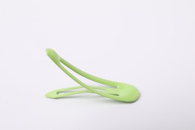 Photo of One green hair clip on white background