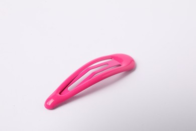 Photo of One pink hair clip on white background