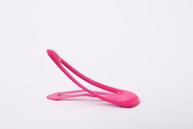 Photo of One pink hair clip on white background