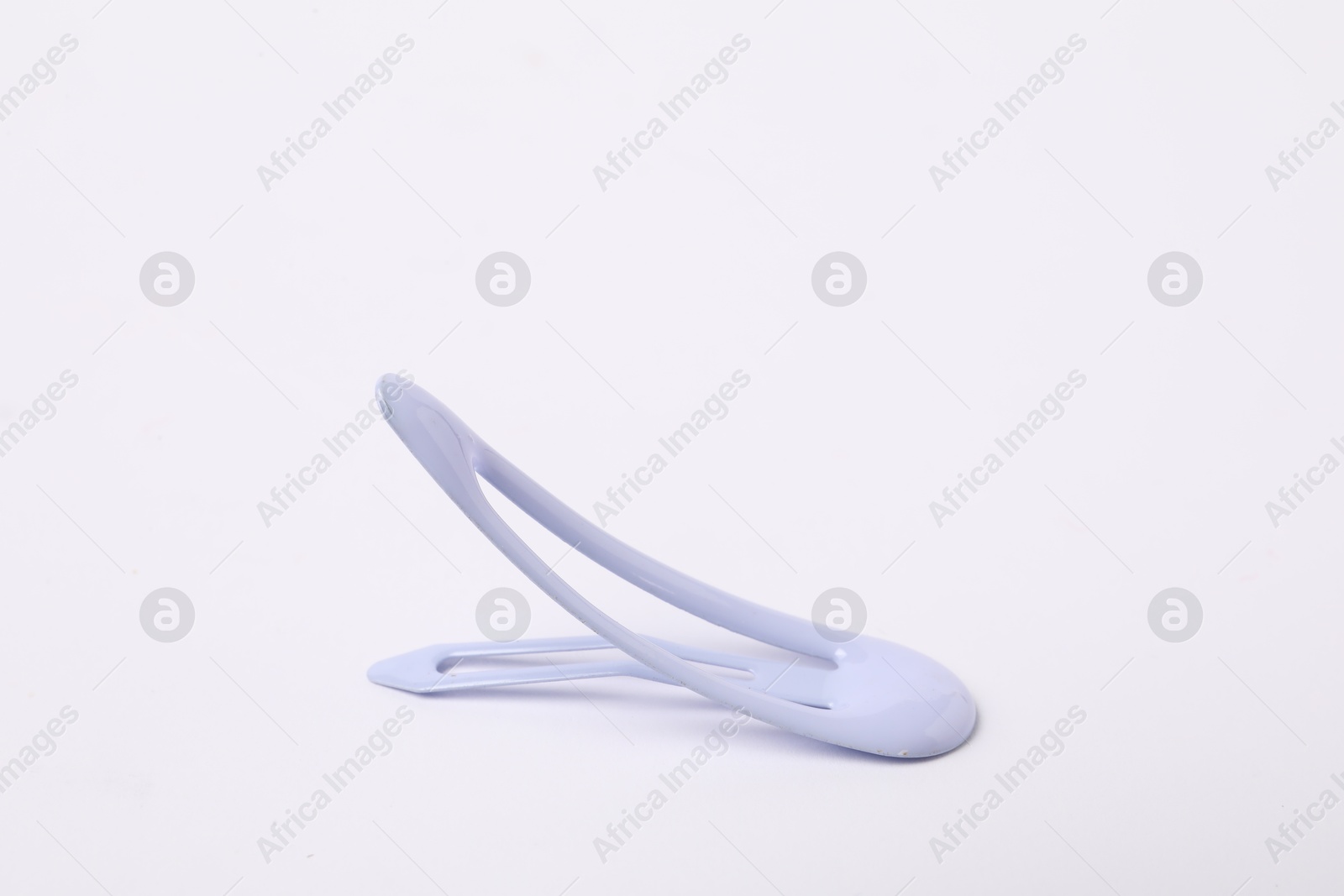 Photo of One blue hair clip on white background