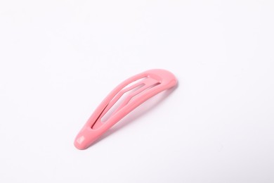 Photo of One pink hair clip on white background