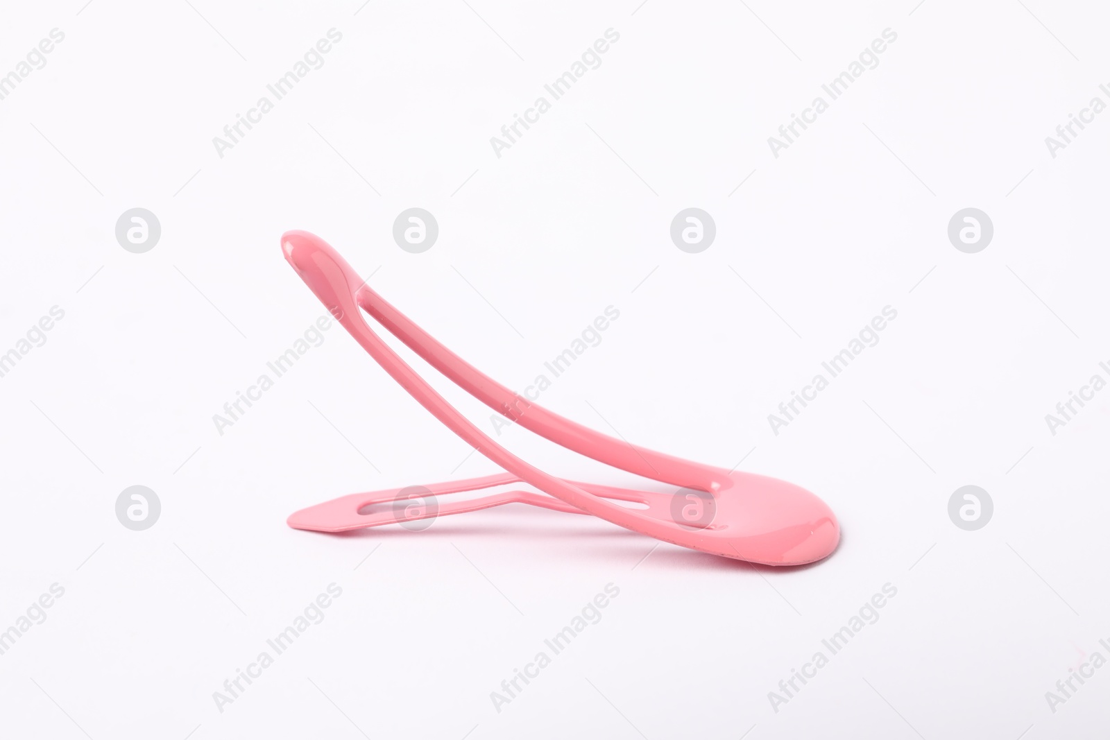 Photo of One pink hair clip on white background