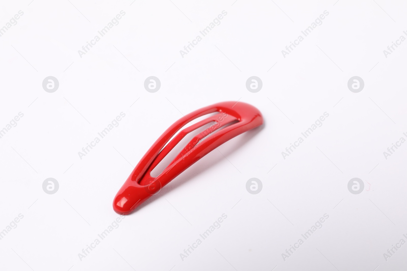 Photo of One red hair clip on white background