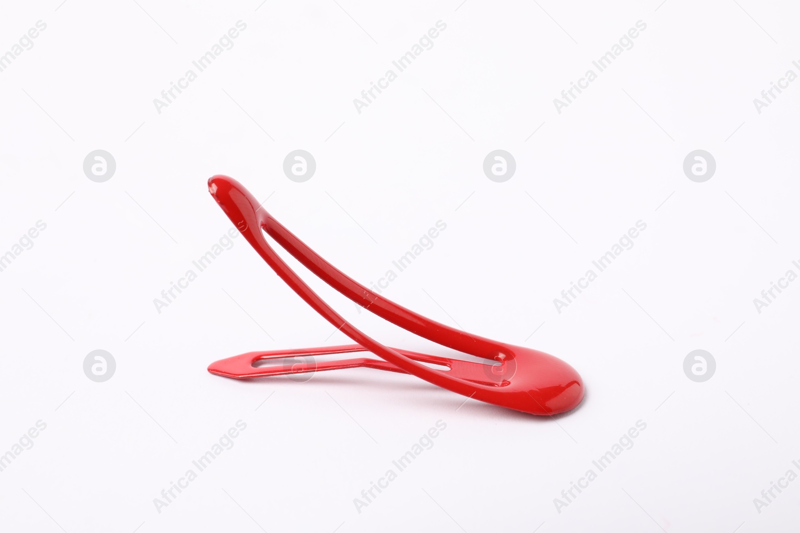 Photo of One red hair clip on white background